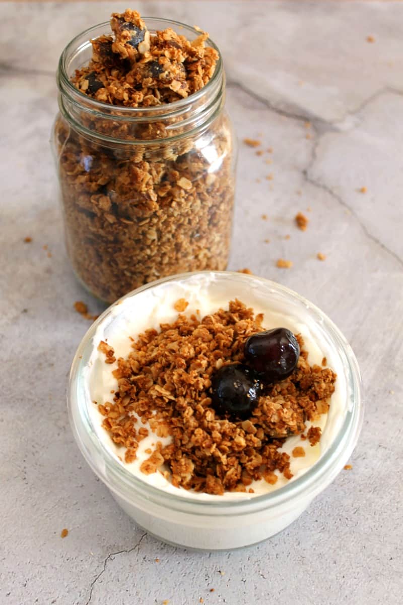 Granola jar and pot of yoghurt topped with granola