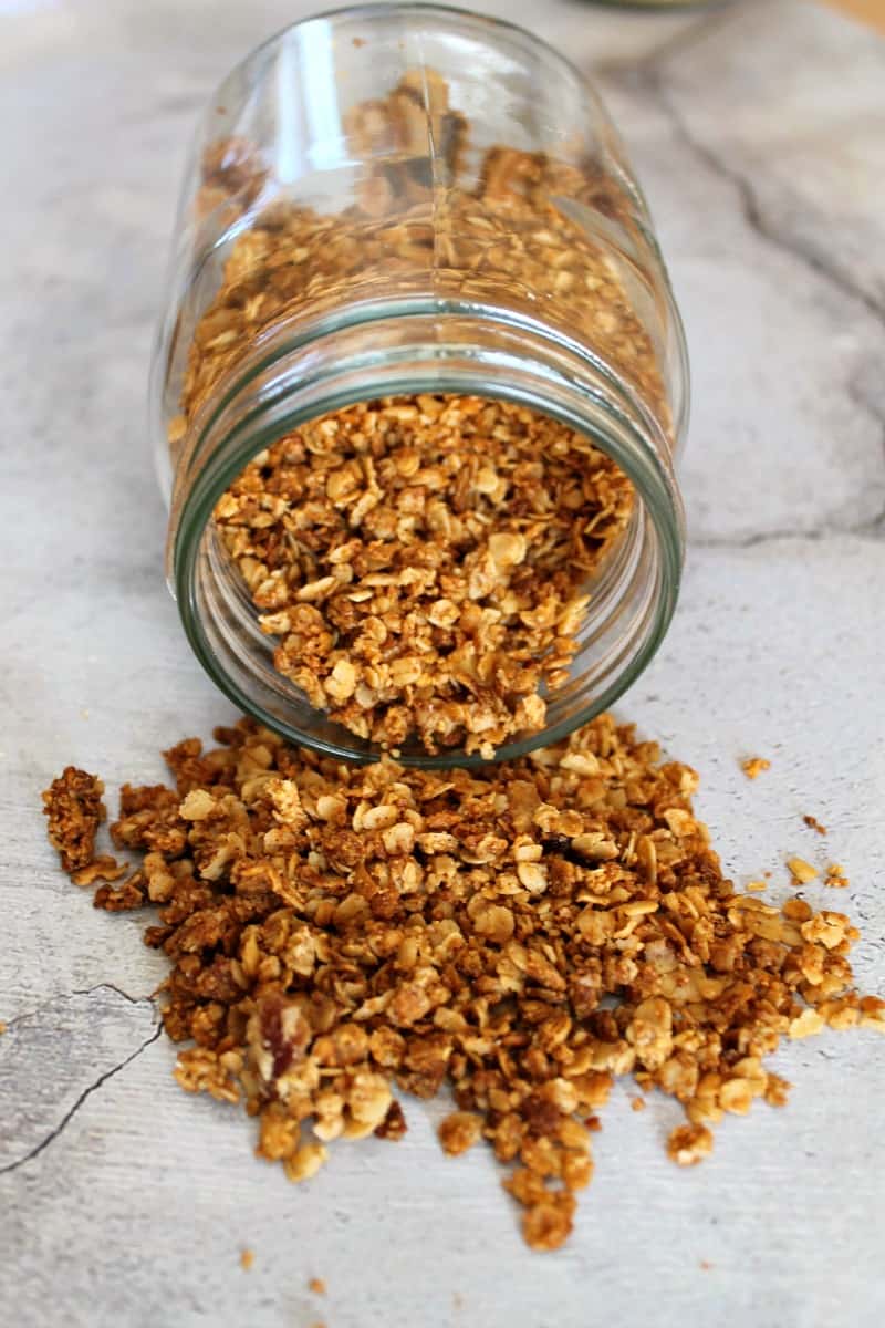 Granola spilling out of a glass jar