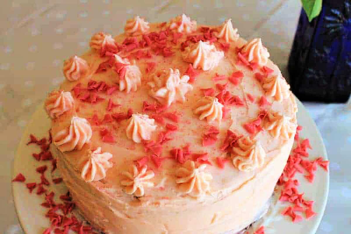 Pink cake with piped icing.