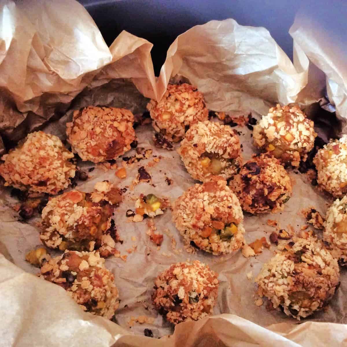 Croquettes cooking in a lined slow cooker pot.