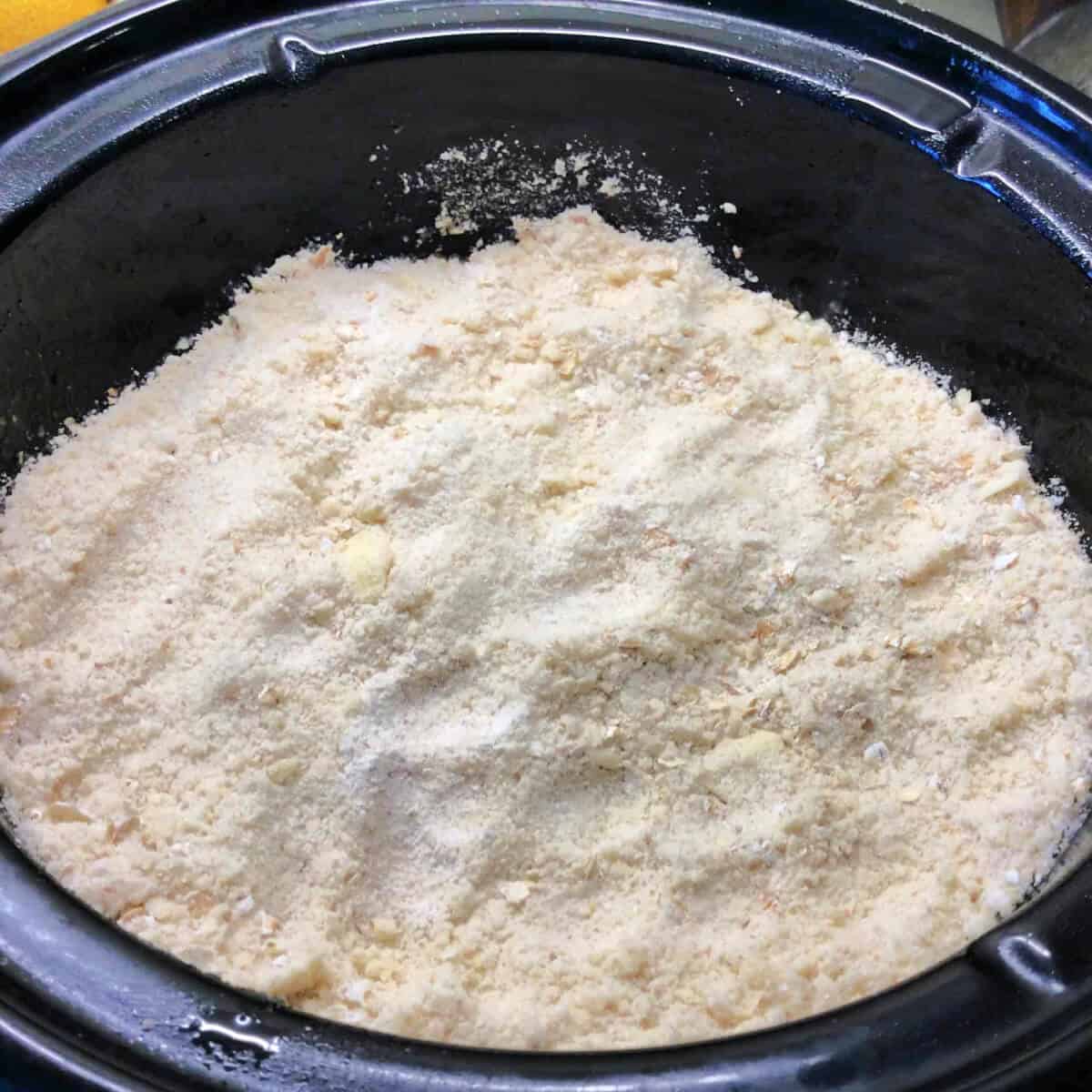 Crumble assembled in slow cooker.