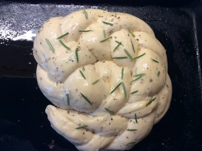 Braided sage bread on tray before baking.