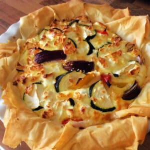 Filo pie with courgette in a round pie dish.