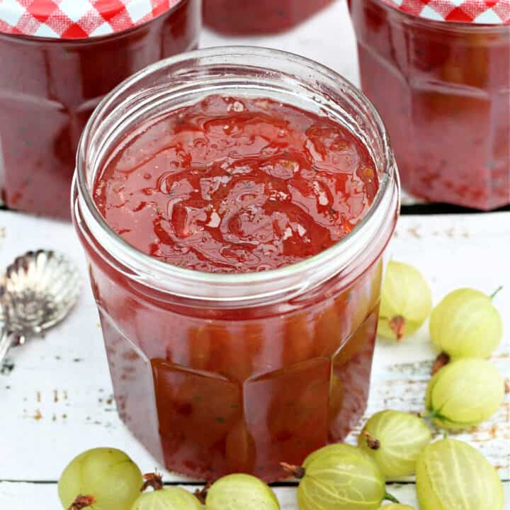 Close up of open jar of gooseberry jam.