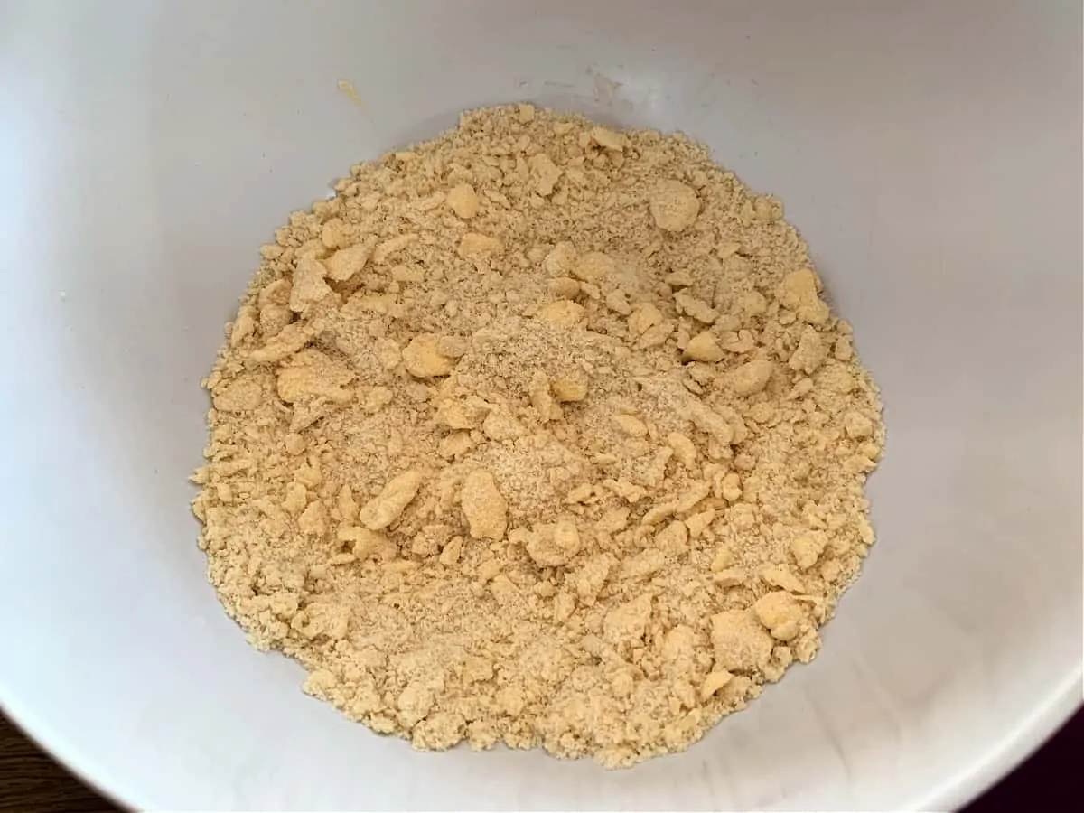 Crumble mixture (large breadcrumb texture) in a white bowl.
