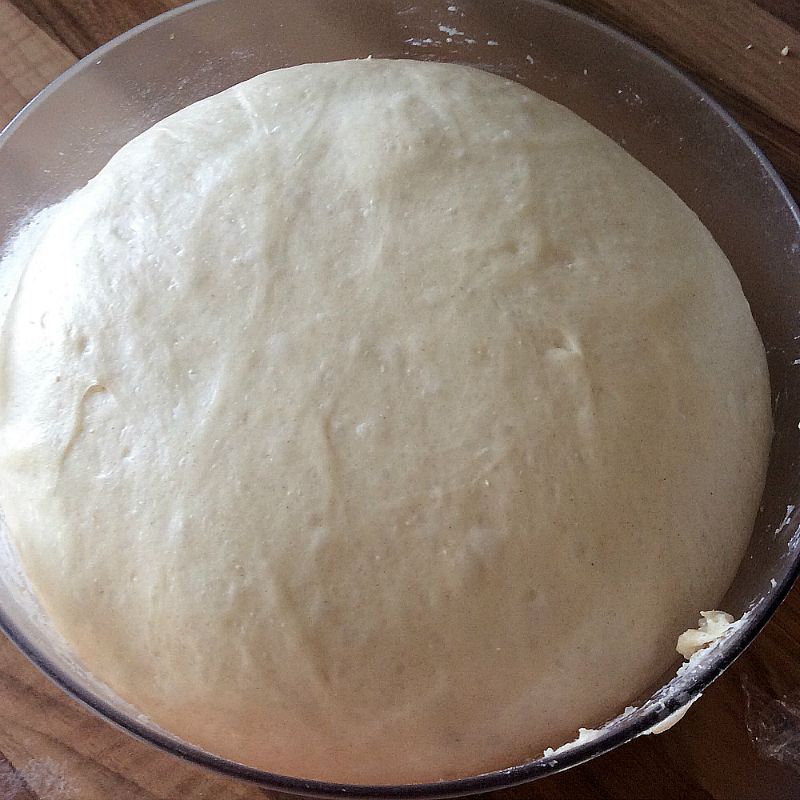 Dough rising well in a clear bowl.