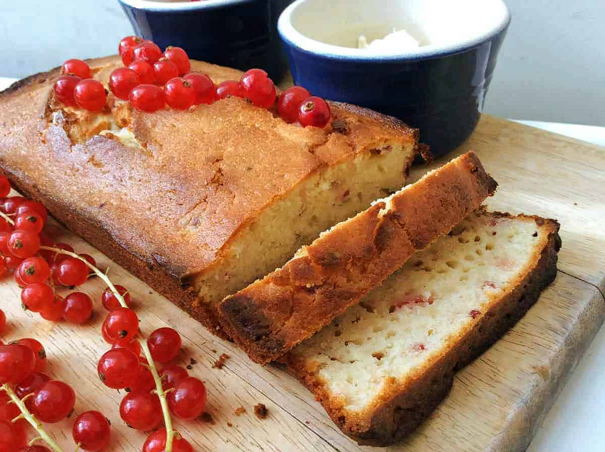 Loaf cake sliced on wooden board.