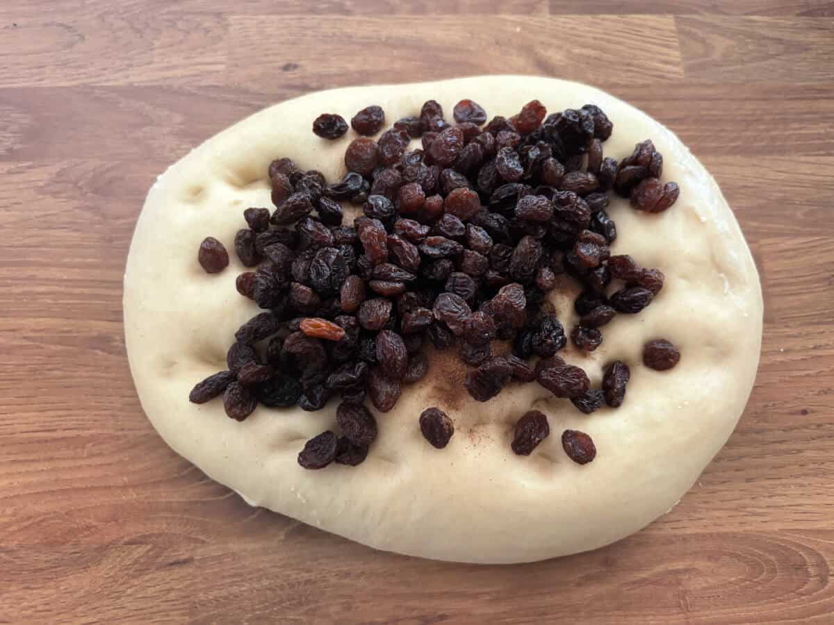 Dough with raisins on top.