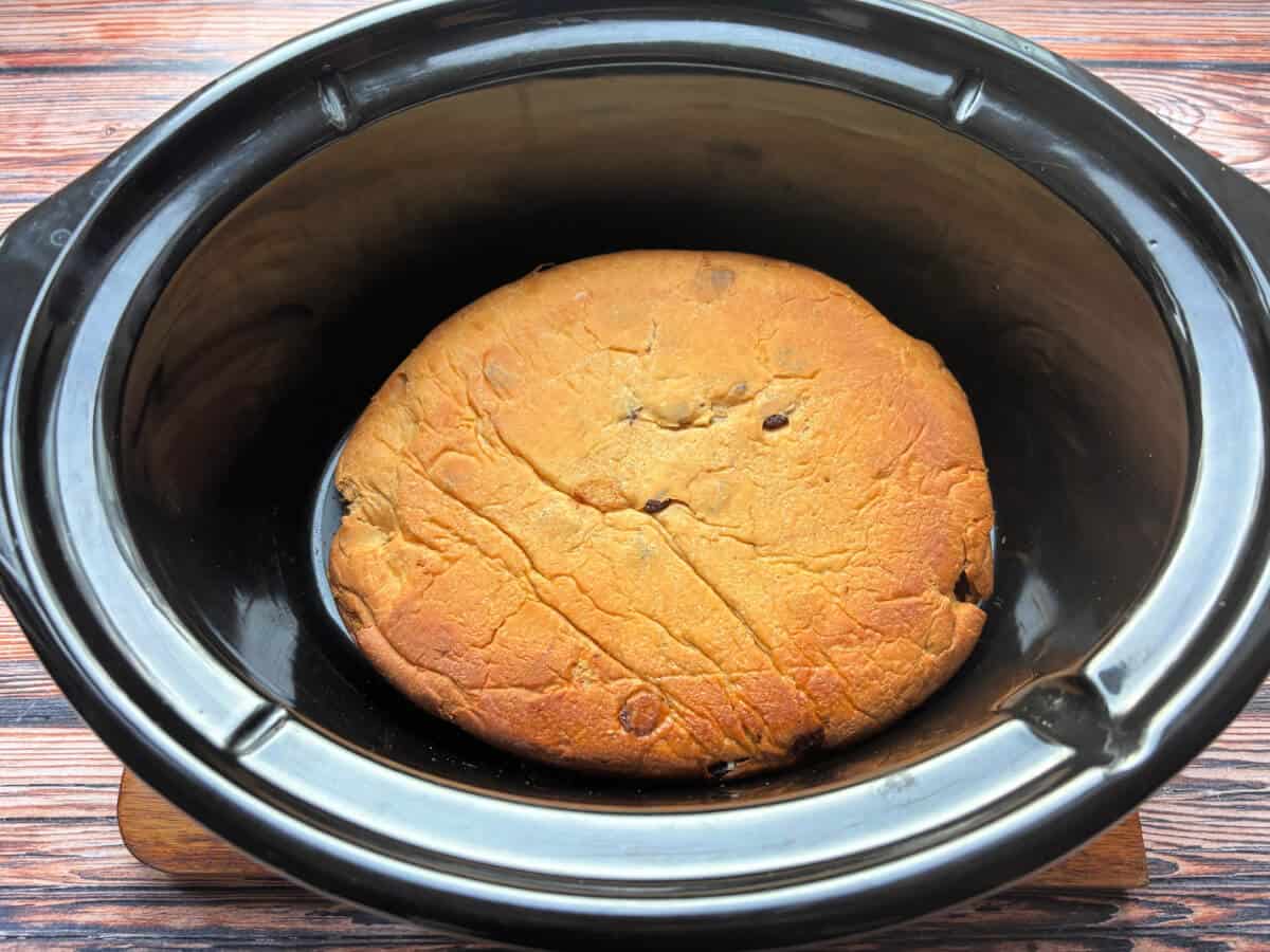 Cooked cinnamon raisin bread in slow cooker pot.