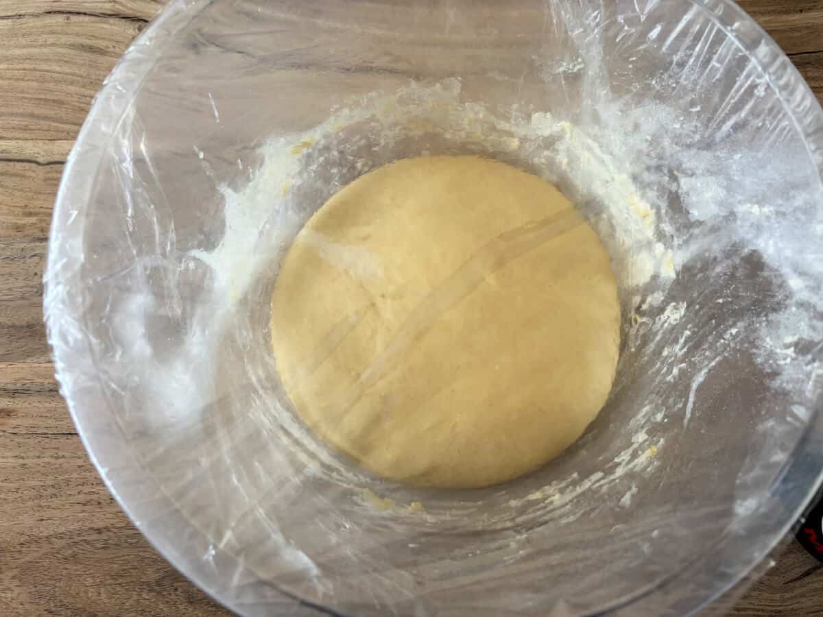 Dough in a covered bowl, after proving.
