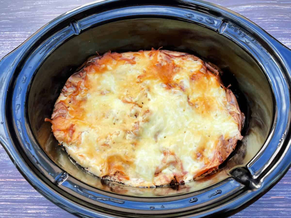 Cooked lasagne in slow cooker pot.