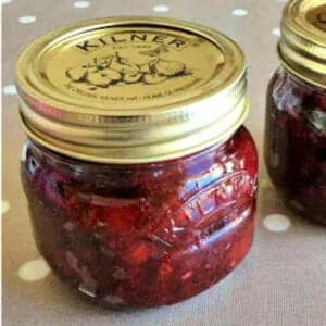 Close up of a small jar of red jam.
