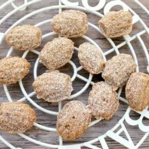 Little madeleine cakes on a white rack.