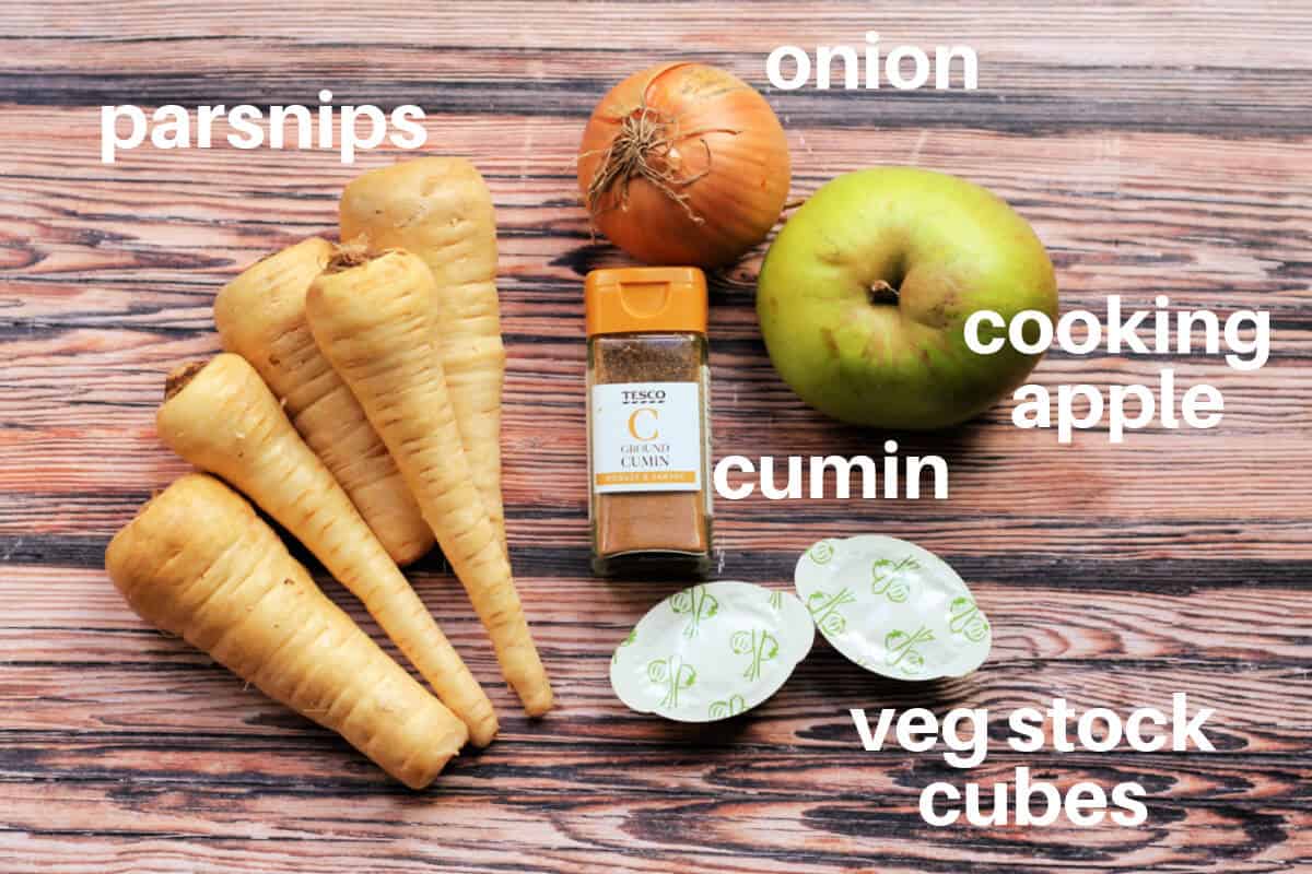 Labelled ingredients for parsnip soup on wooden table.