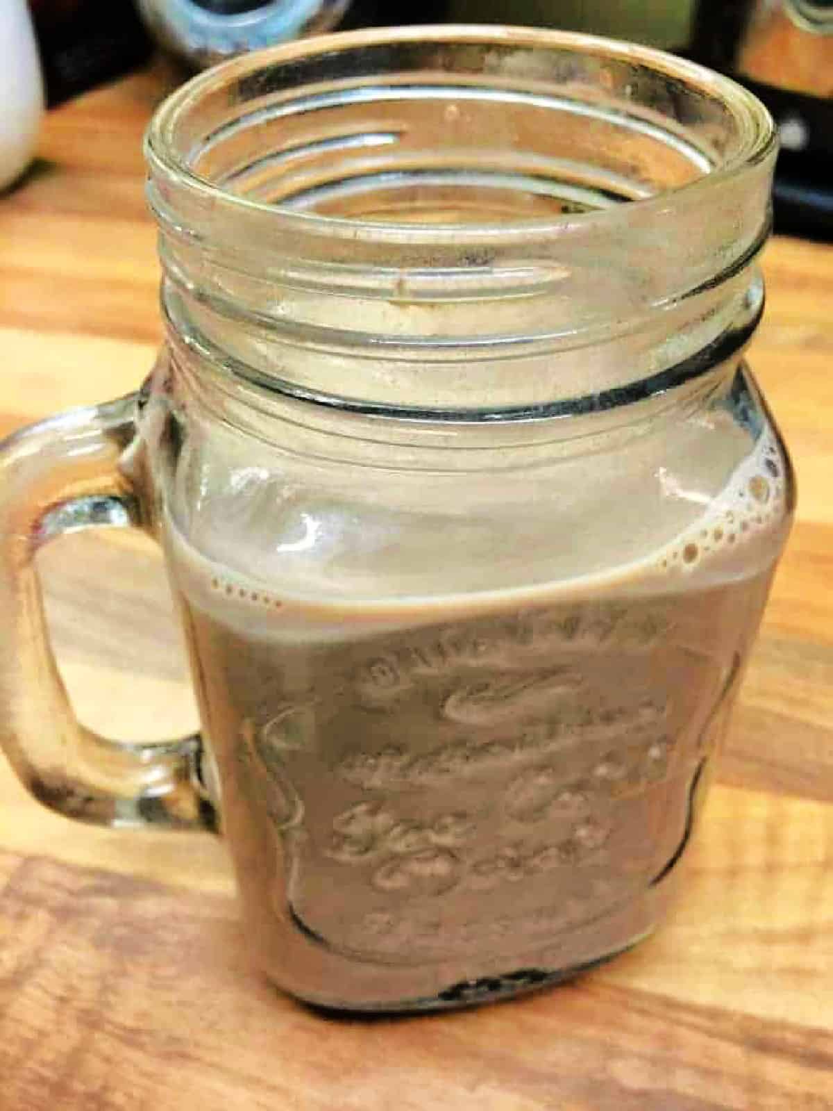 A glass mug jar of hot chocolate.