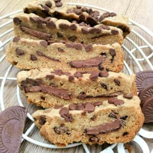 A large chocolate chip cookie with chocolate orange in the centre, in slices.