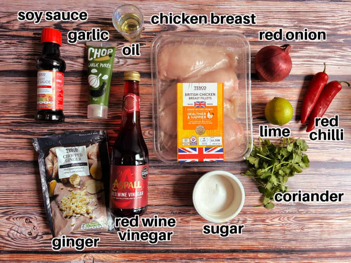 Labelled ingredients for chilli lime chicken on wooden table.