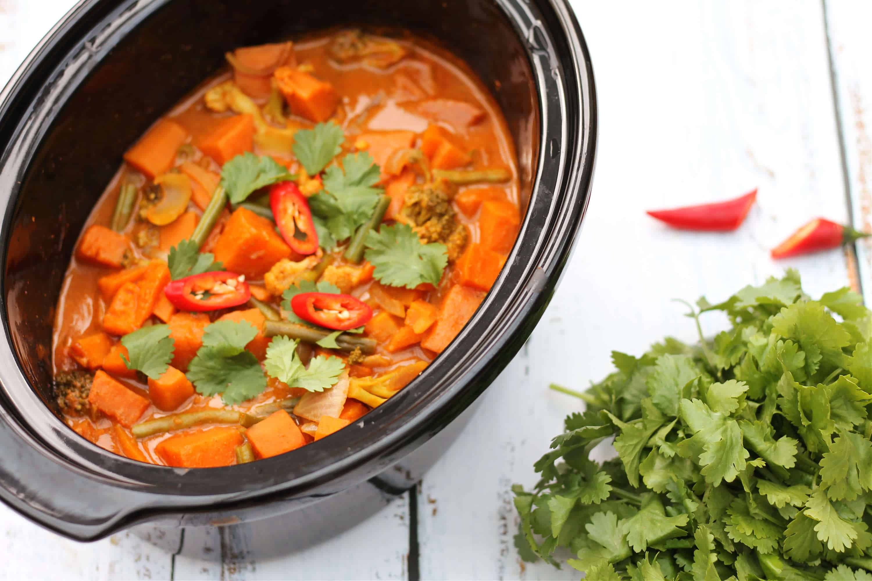 Slow cooker curry topped with sliced red chilli and coriander leaves, ready to serve.