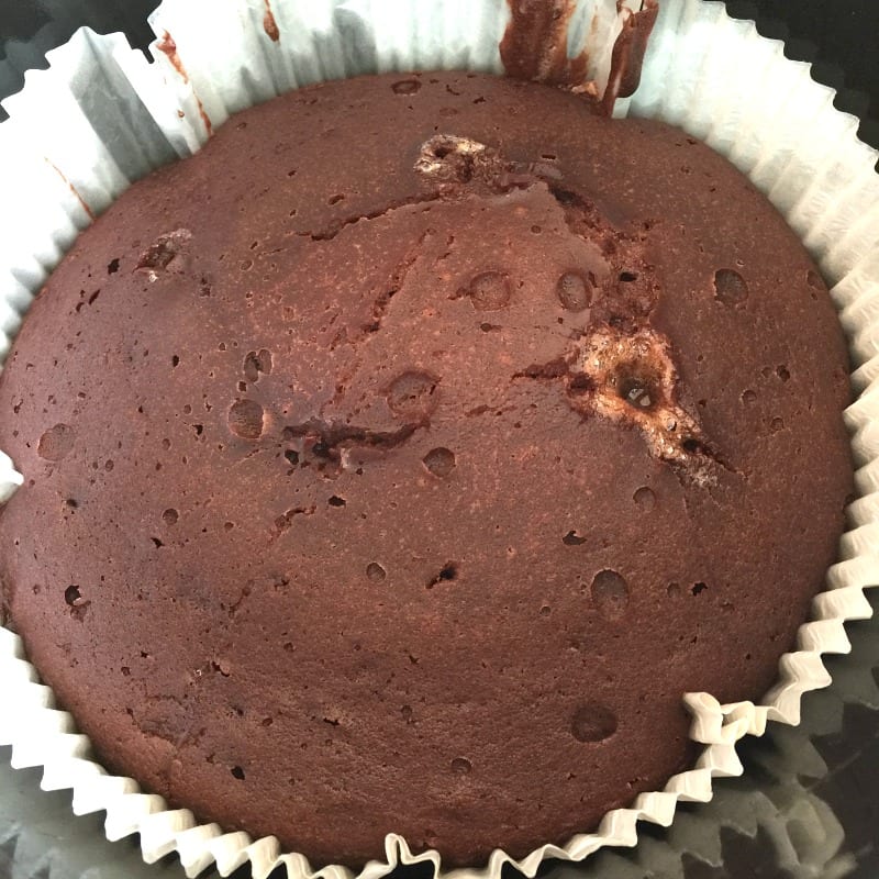 Cooked chocolate cake in slow cooker pot.