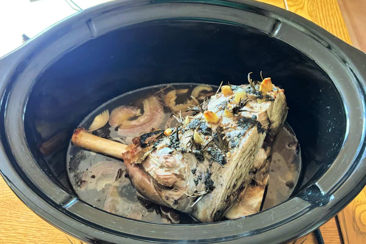 Cooked lamb in slow cooker pot.