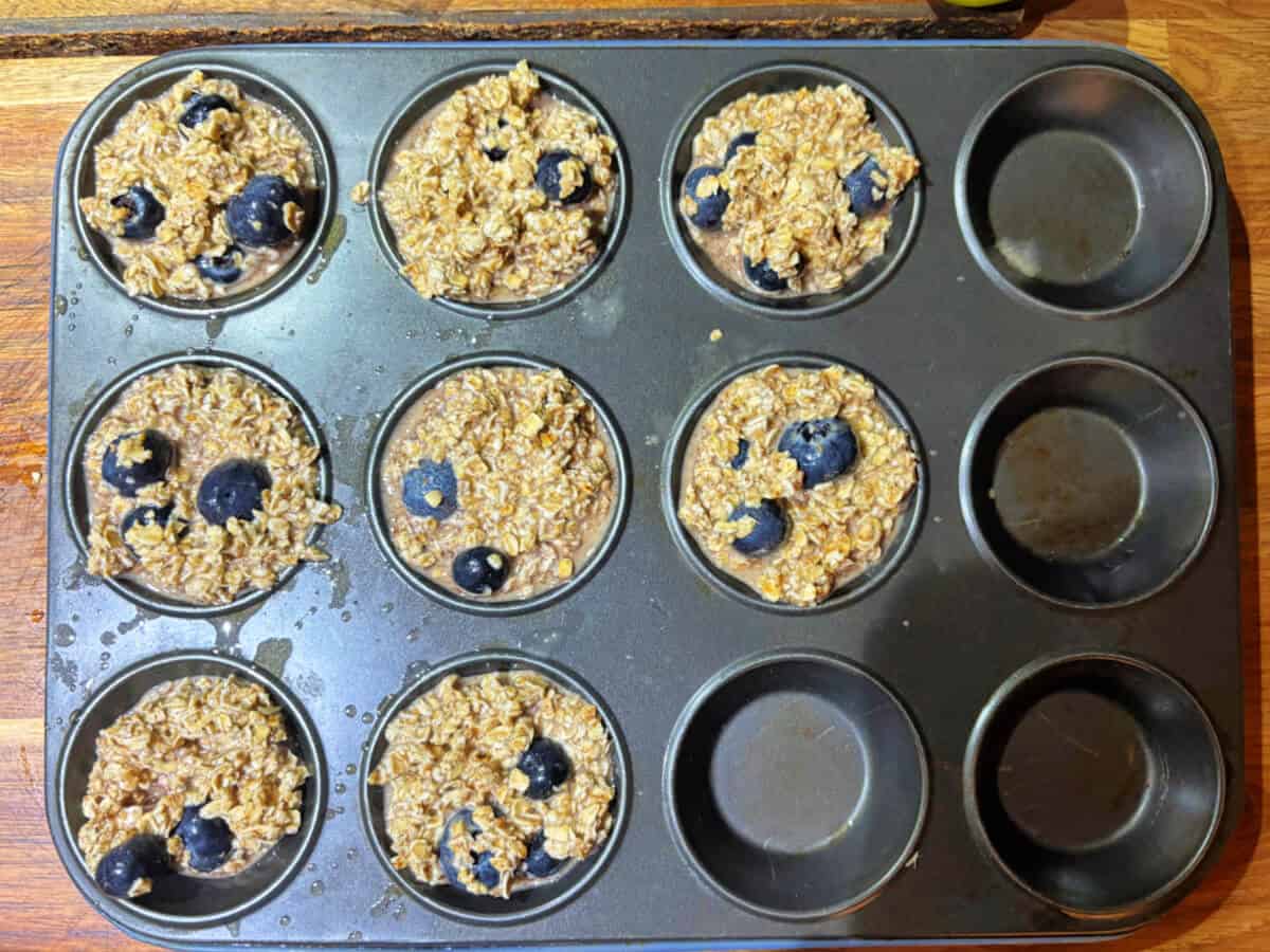 Baked oat mixture in muffin tin, before baking.