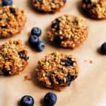 Mini cinnamon and blueberry baked oat cups, with fresh blueberries.