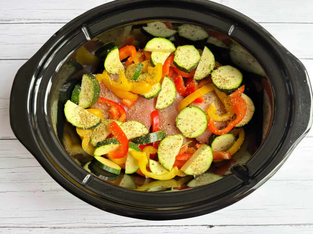 Veg with oregano in slow cooker pot.