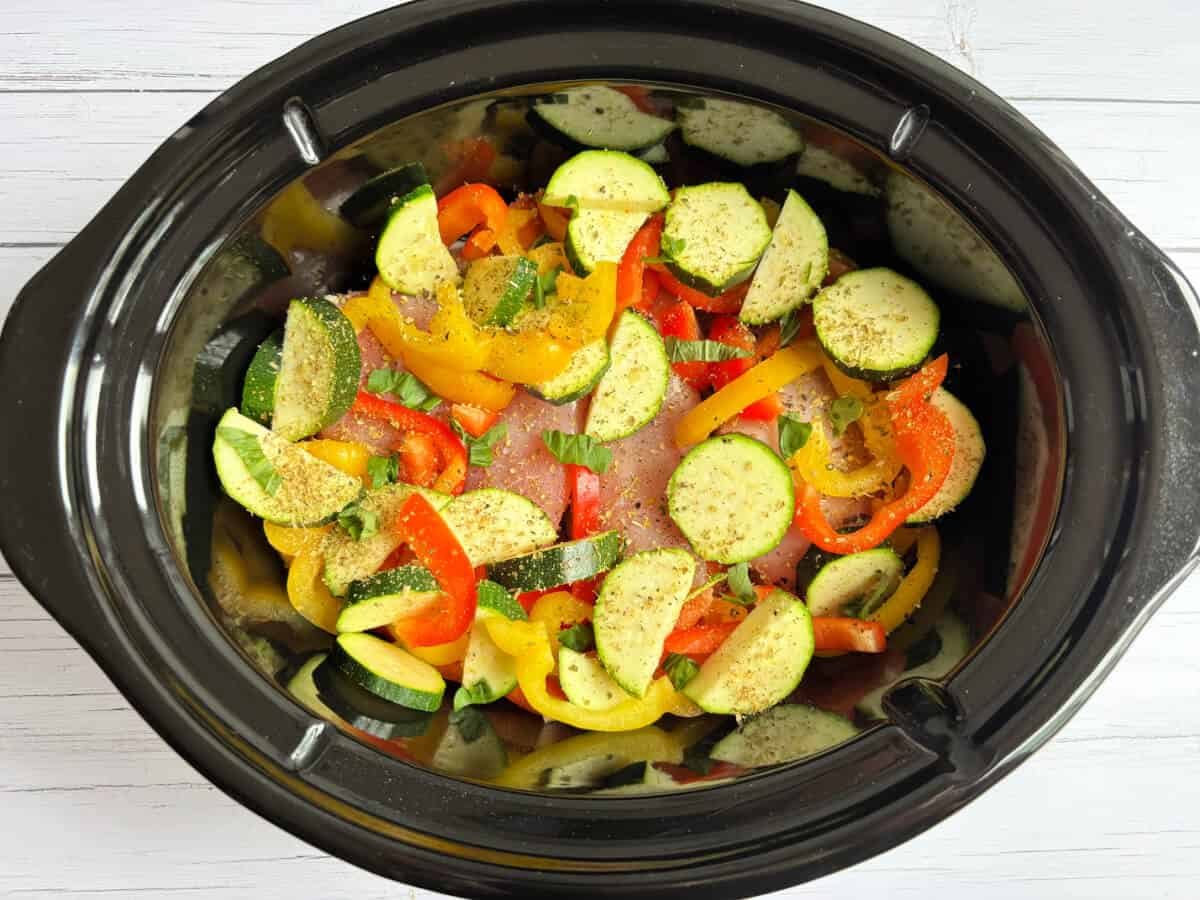 Mediterranean vegetables with a little basil in pot.