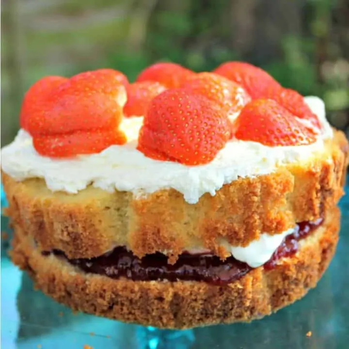 Close up of cake with strawberries on top.