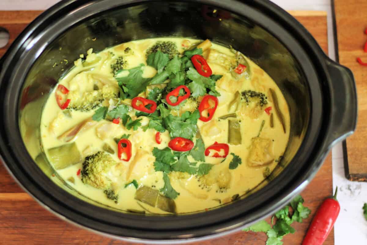 Fish curry ready to serve, in slow cooker pot.