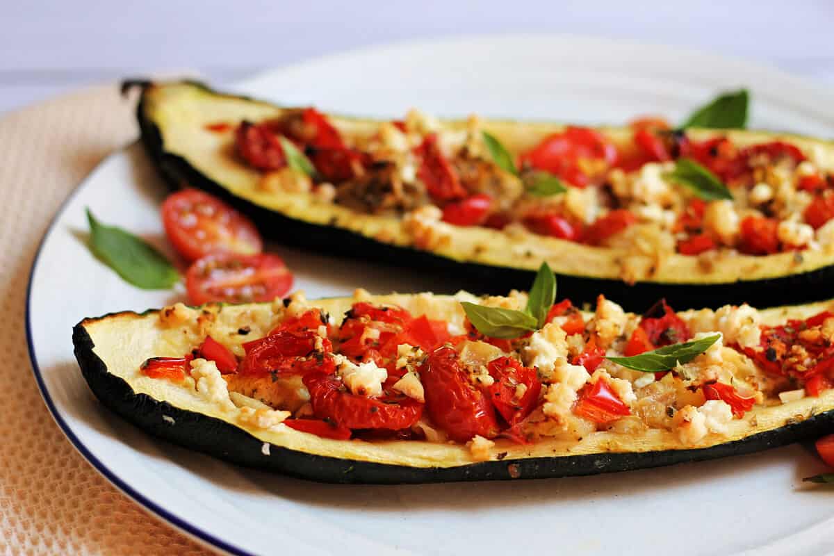 Close up of stuffed courgettes with red pepper and feta filling.