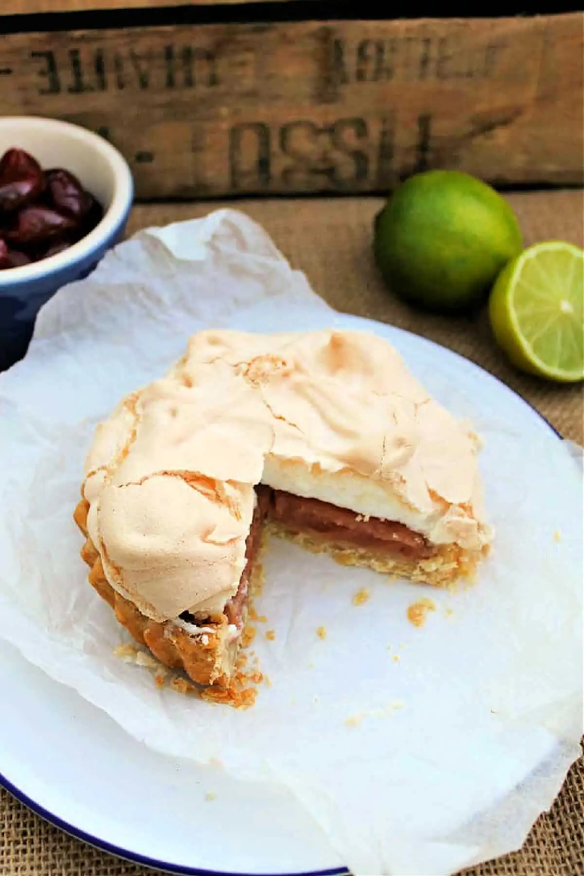 Meringue pie with pink filling with a slice cut out,