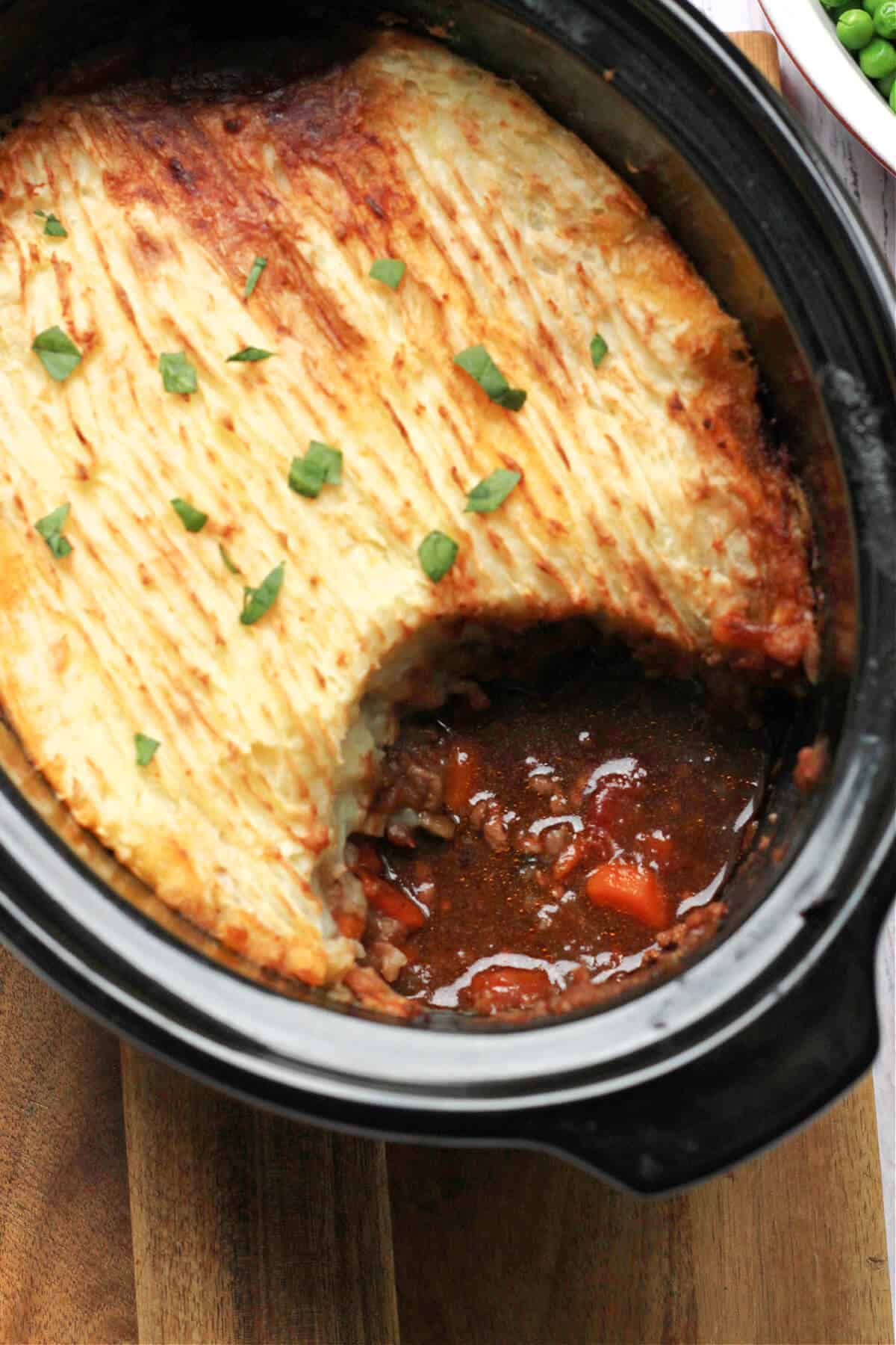 Cottage pie being served from slow cooker insert.