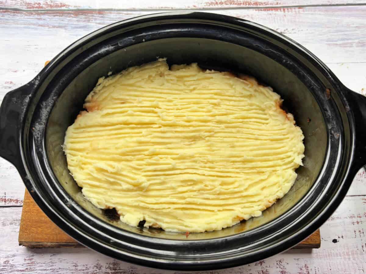 Cottage pie with mash topping in slow cooker pot.