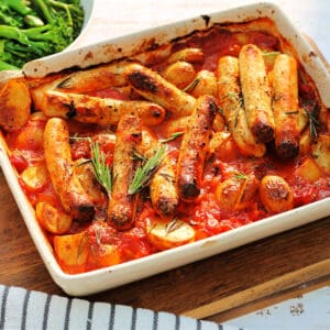 Sausage and potato bake in a white serving dish.