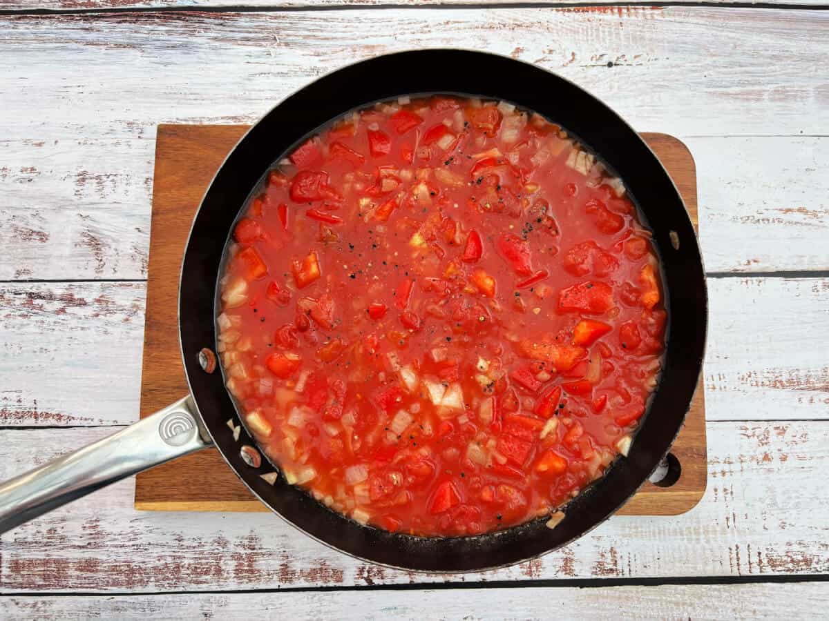 Tomato sauce ingredients in a pan.