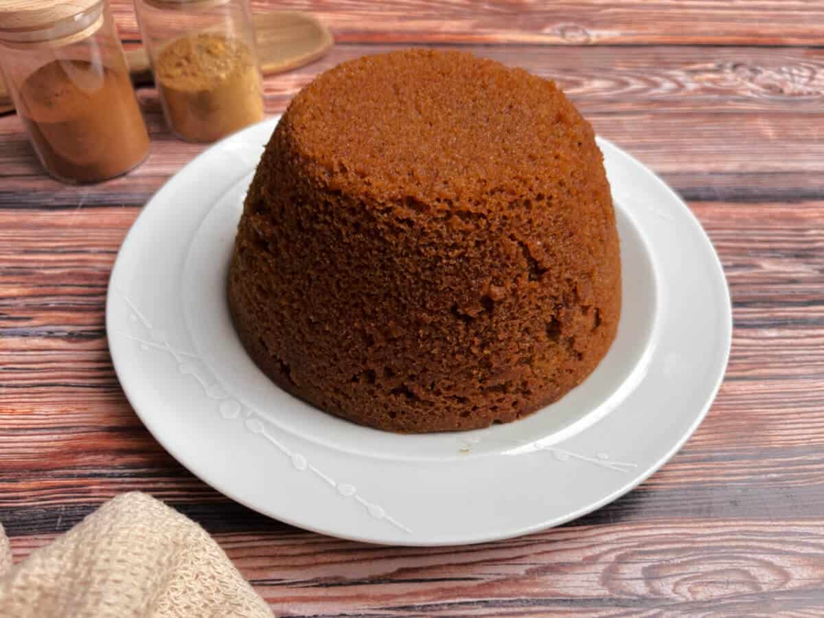 Gingerbread sponge served onto a white plate.