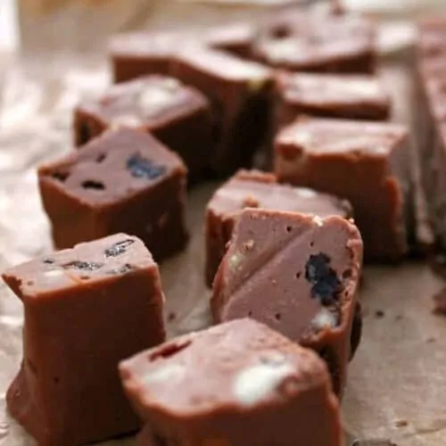 Close up of squares of fudge on a brown background.
