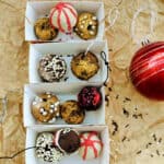 Chocolate truffles decorated as baubles in small cardboard trays.