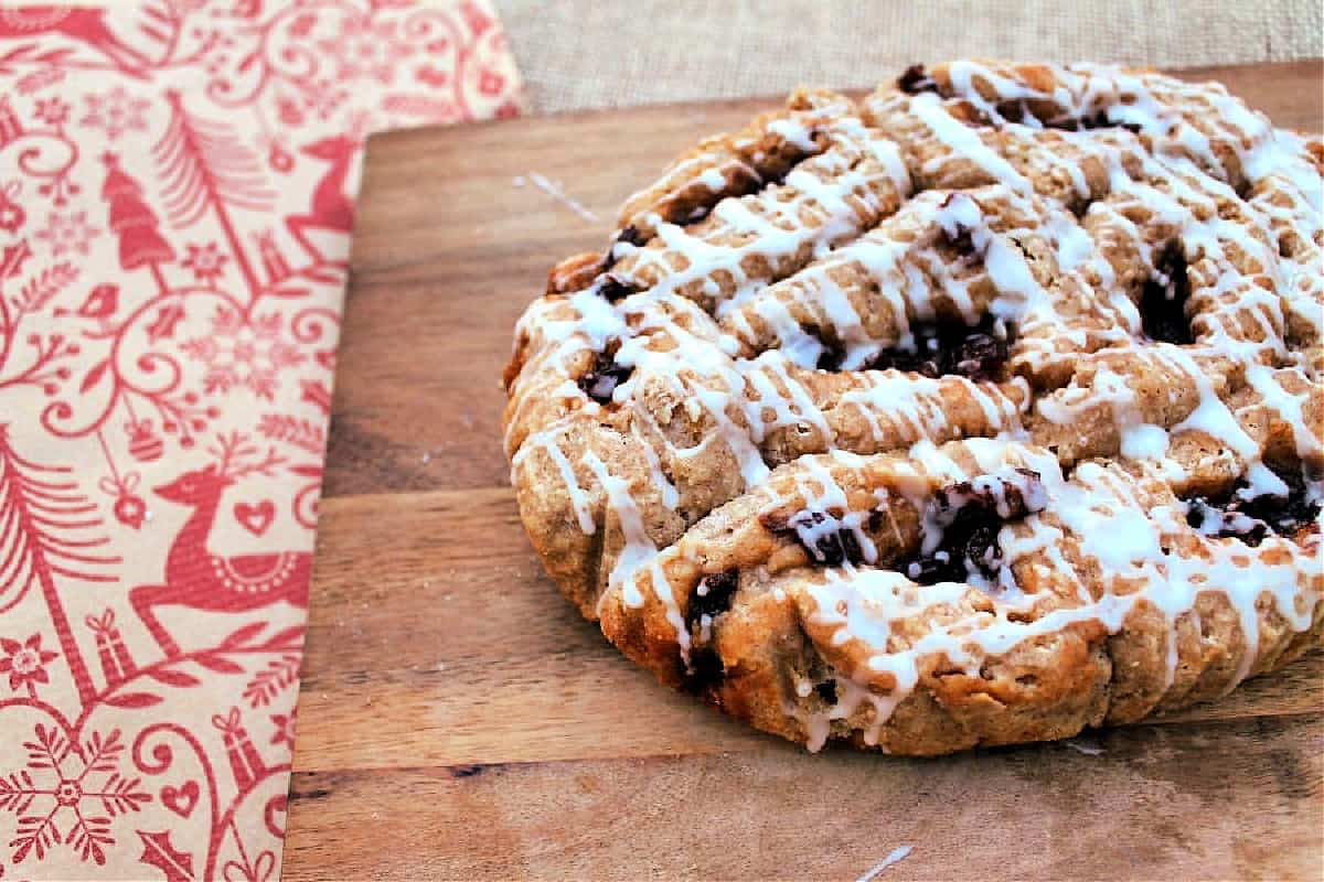 Mincemeat swirls on wooden cutting board, drizzled with white icing.