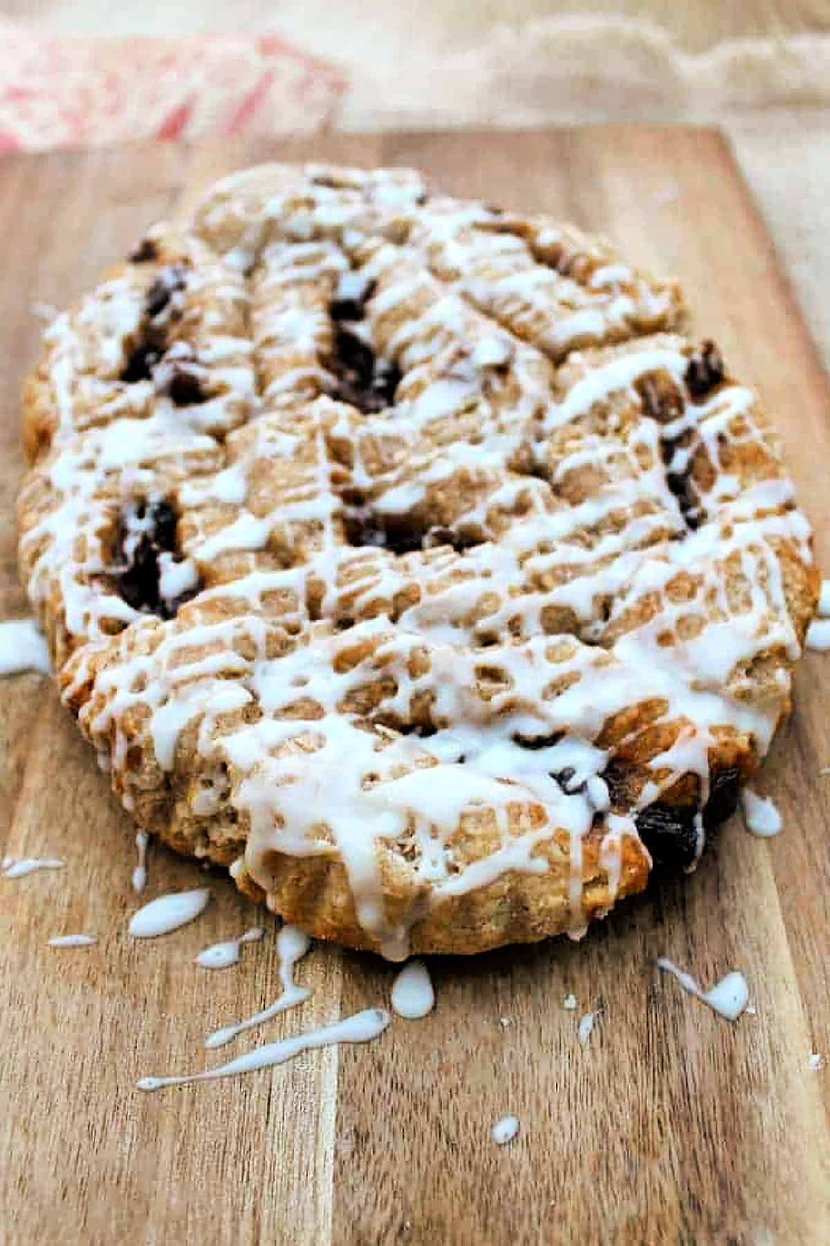 Mincemeat swirls on wooden cutting board, drizzled with white icing.