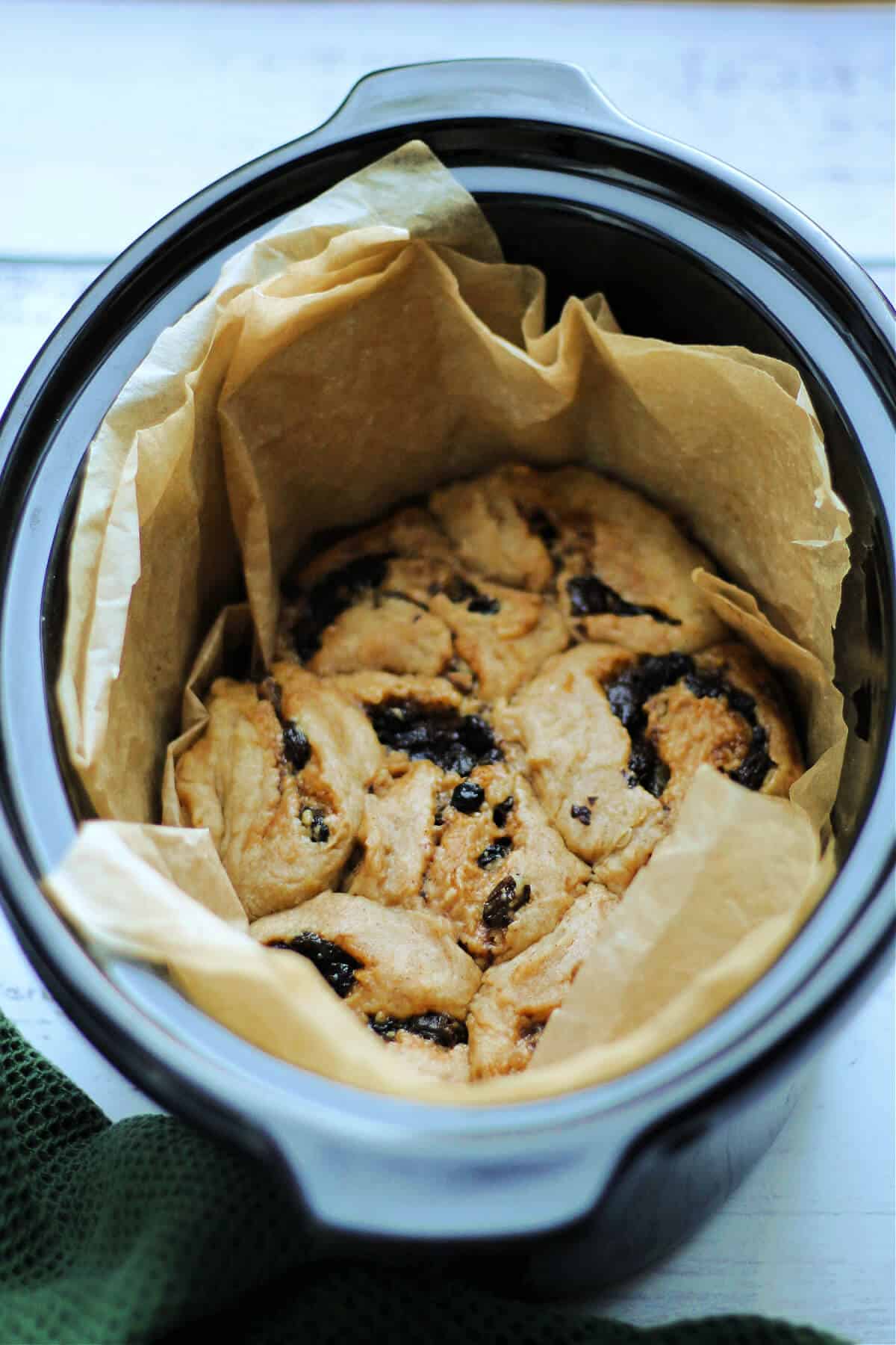 Mincemeat swirls in slow cooker pot lined with baking paper.