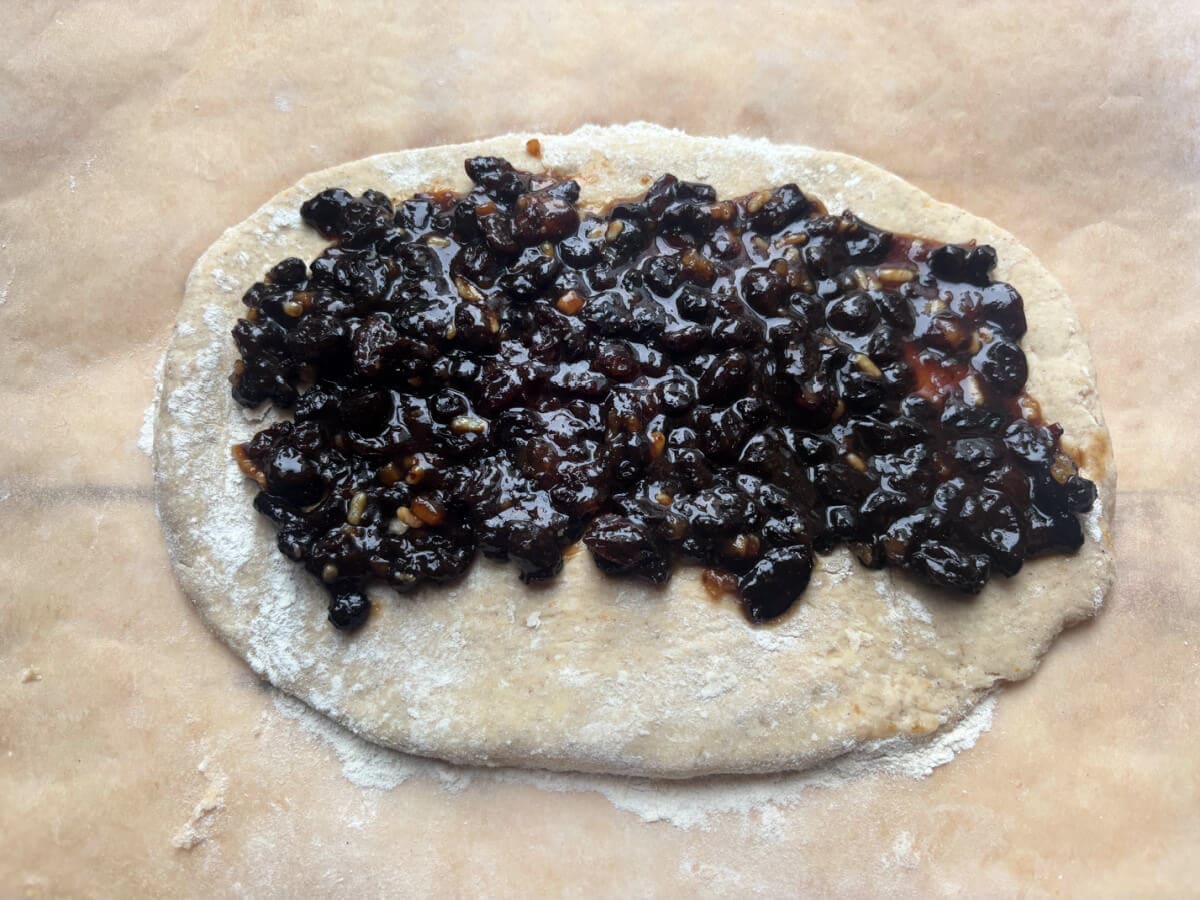Dough with mincemeat spread on top.