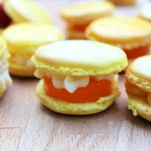 Lemon macarons with jelly and piped filling.