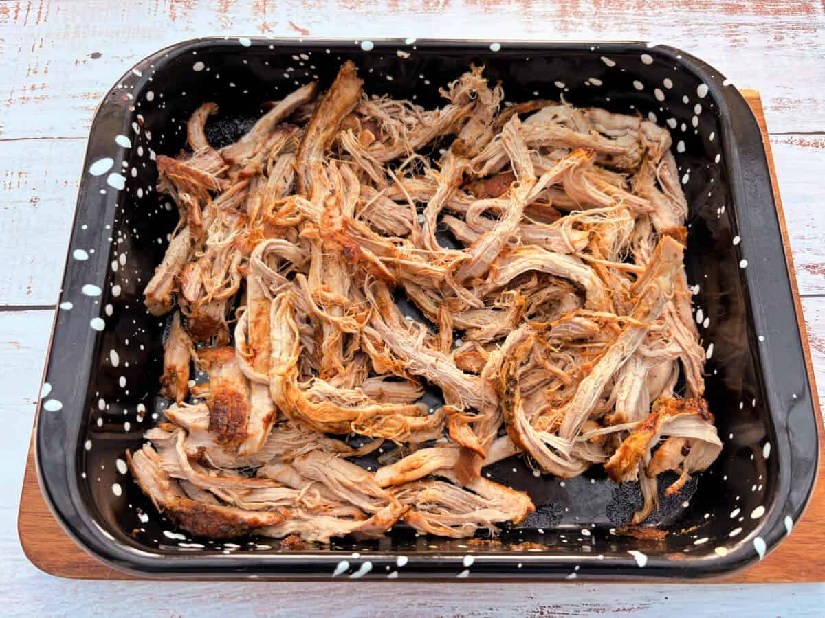 Shredded pork in an oven tray.