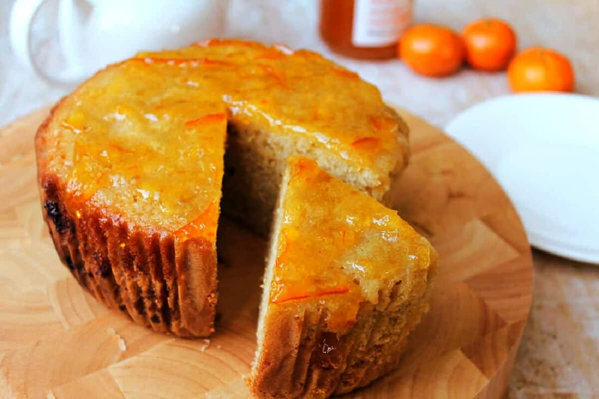 Orange cake with one slice cut out.