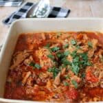 Paprika pork goulash in a serving dish with spoon and napkin