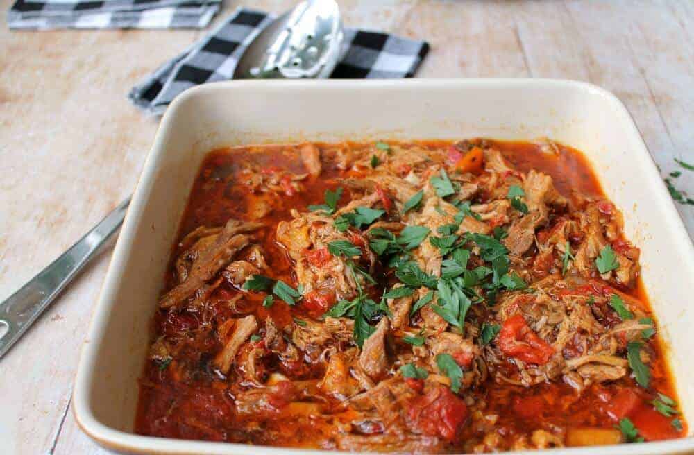 Paprika pork goulash in a serving dish with spoon and napkin
