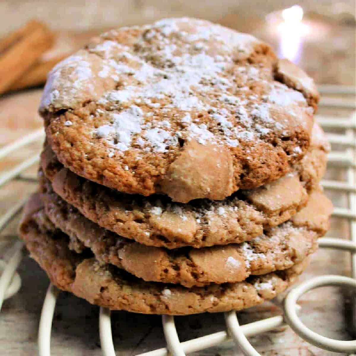 A stack of cookies with powdered sugar dusted on top.