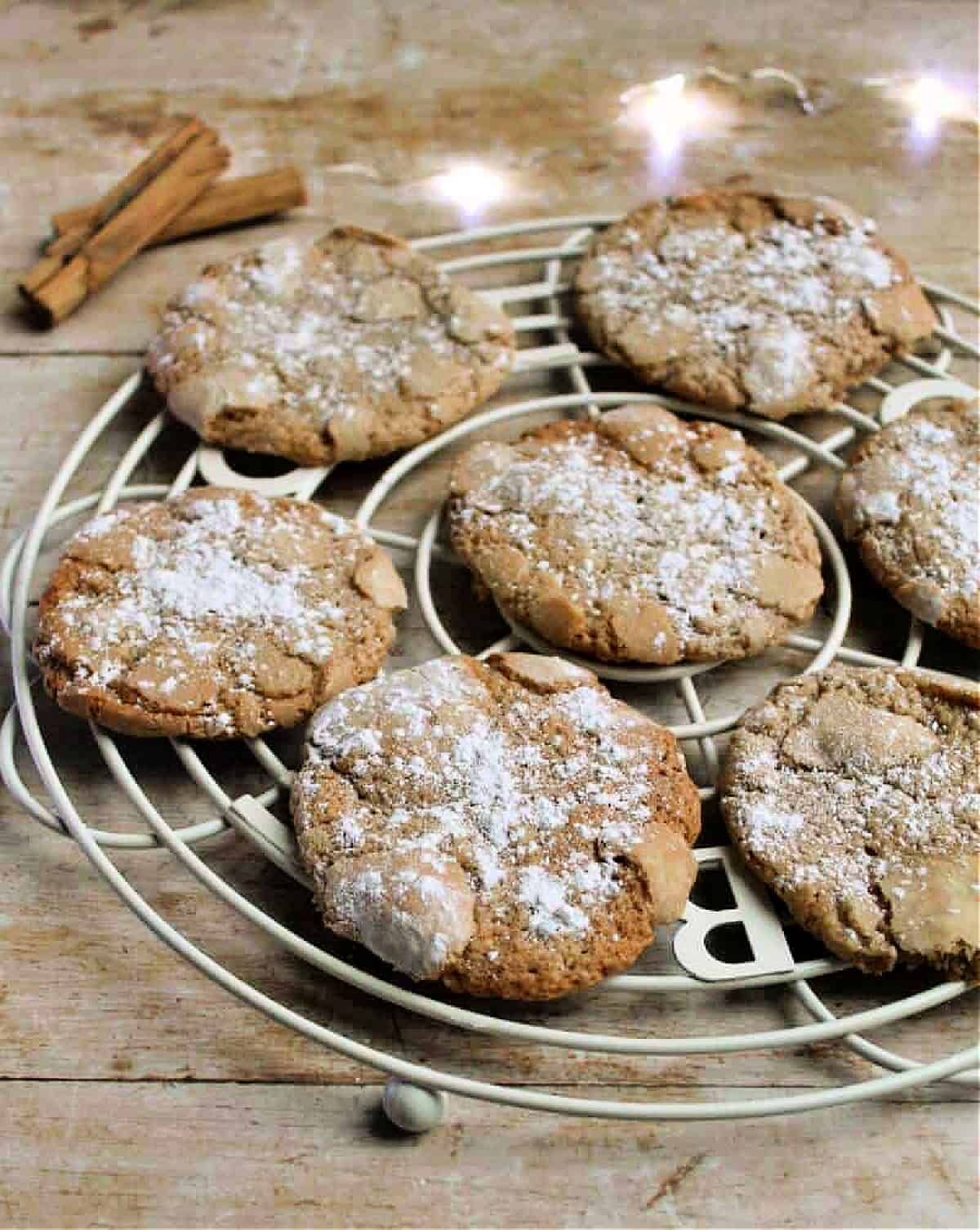 Crackle cookies on a cooling rack, fairy lights in background.